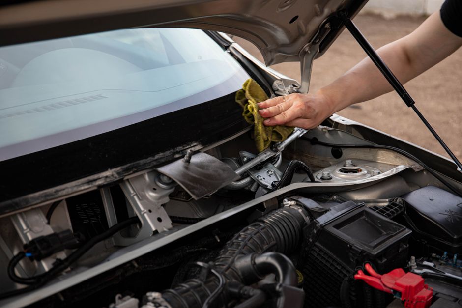 Technician performing a complete windshield replacement