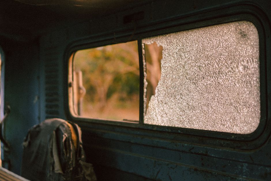 Detail of a broken auto glass being prepped for chip repair